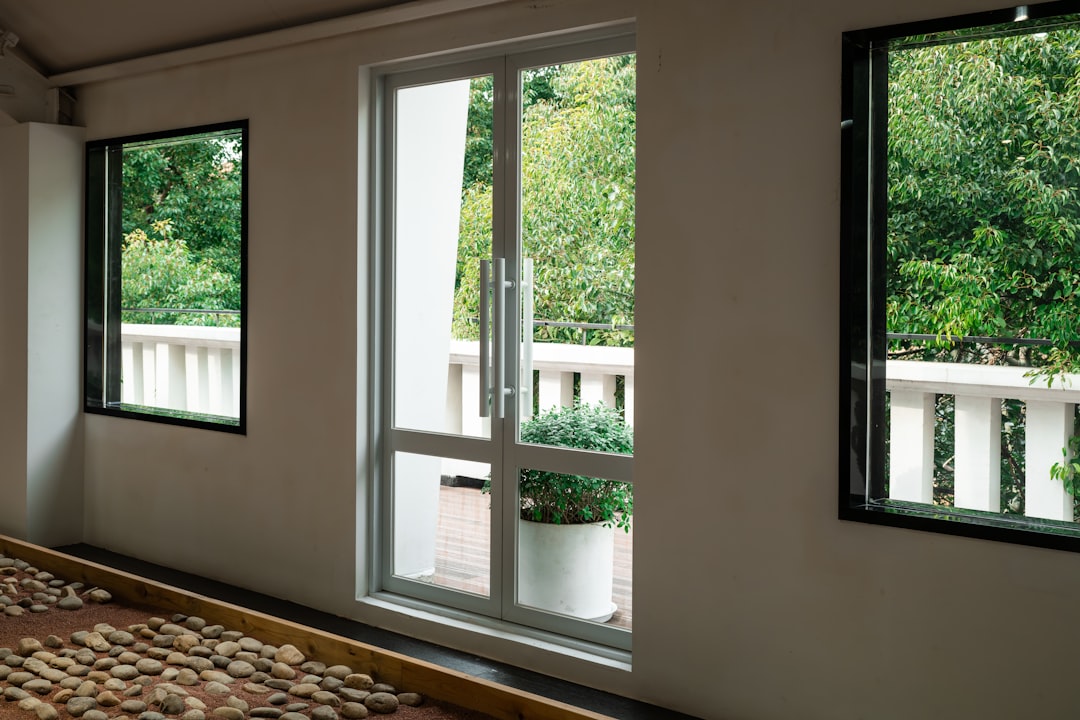 a-bed-sitting-under-three-windows-in-a-bedroom-16hlvscuhee